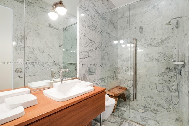 bathroom with vanity, toilet, tiled shower, and tile walls