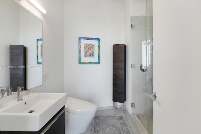 bathroom featuring an enclosed shower, vanity, toilet, and tile patterned floors