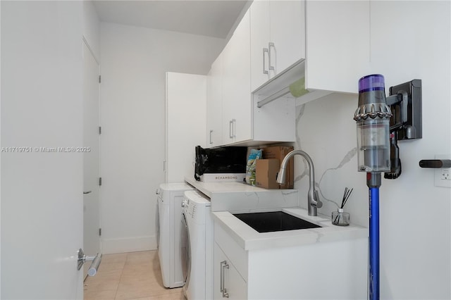 laundry area with washer and dryer, sink, light tile patterned flooring, and cabinets