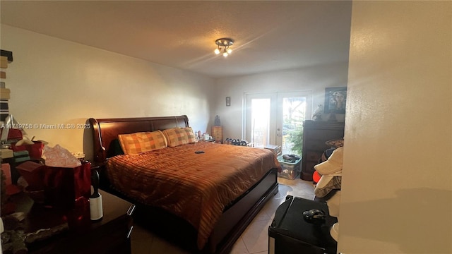 tiled bedroom featuring french doors