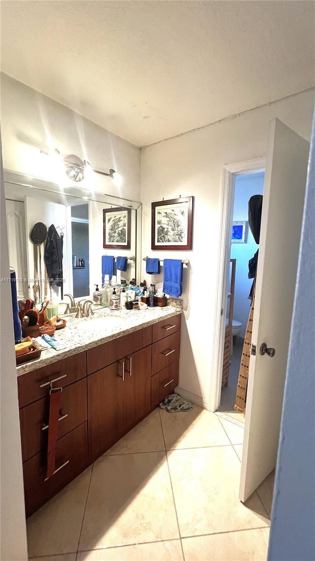 bathroom with ceiling fan, vanity, and tile patterned flooring