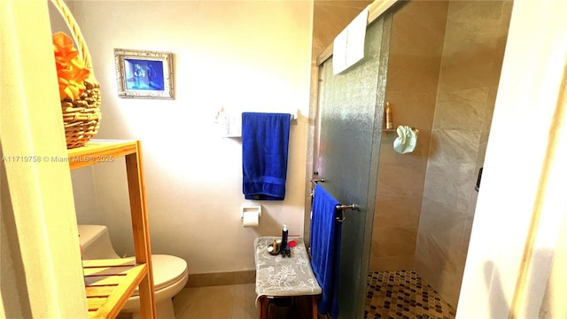 bathroom featuring toilet and an enclosed shower