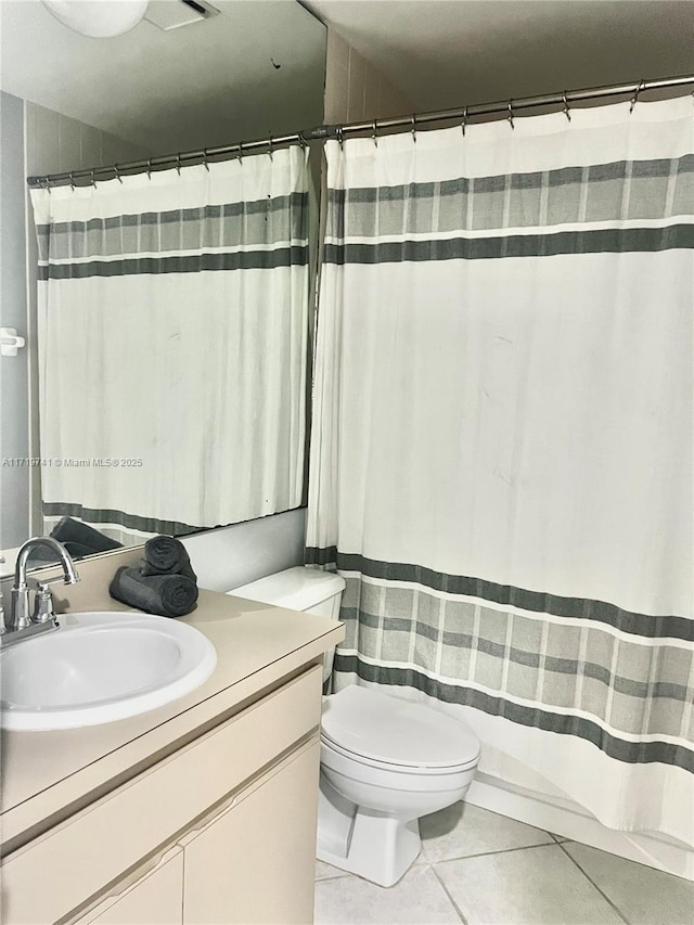 bathroom with tile patterned flooring, vanity, toilet, and a shower with shower curtain