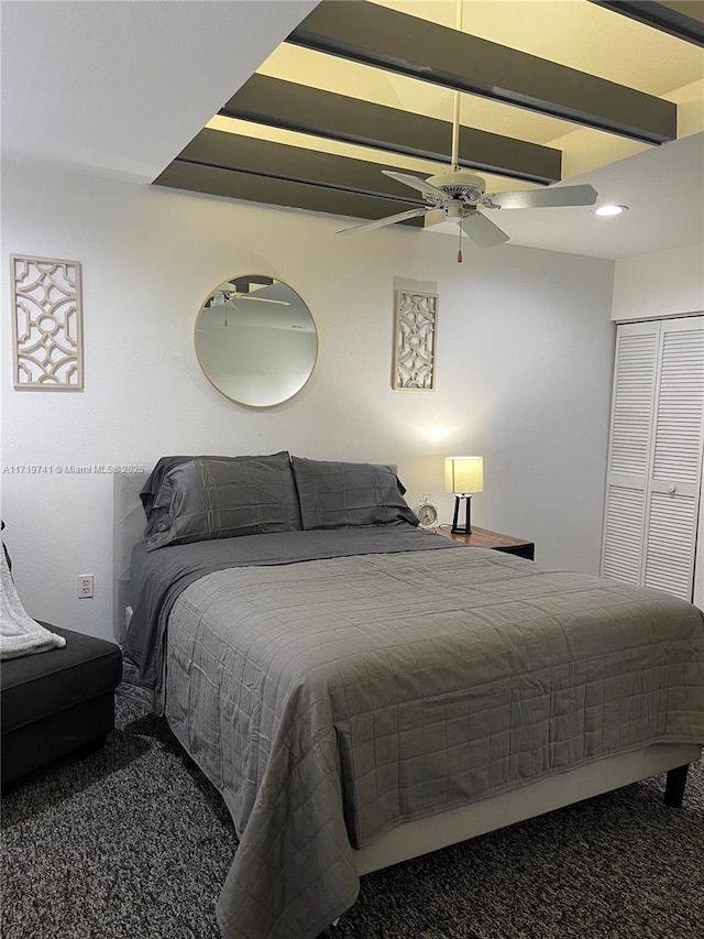 bedroom with ceiling fan, a closet, and carpet floors