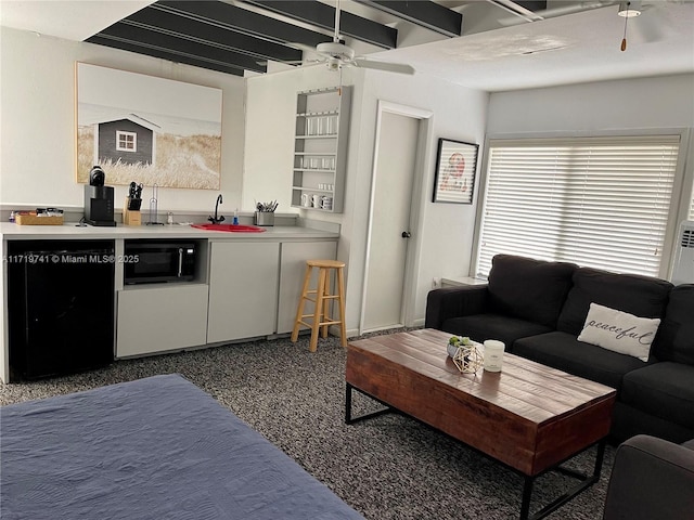 interior space featuring ceiling fan, sink, and black appliances