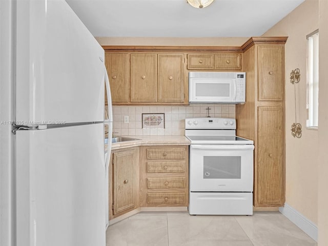 kitchen with white appliances, tasteful backsplash, and sink