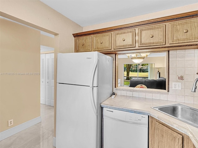 kitchen with white appliances, light tile patterned flooring, backsplash, and sink