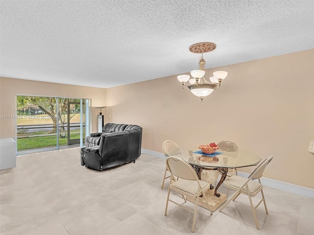 dining area with an inviting chandelier and a textured ceiling