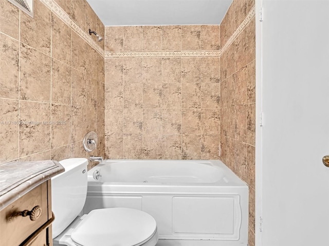 bathroom with tile walls, toilet, and shower / washtub combination