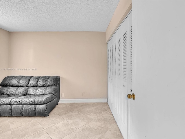 sitting room with light tile patterned flooring and a textured ceiling