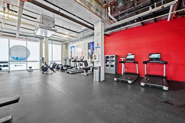 exercise room with a high ceiling