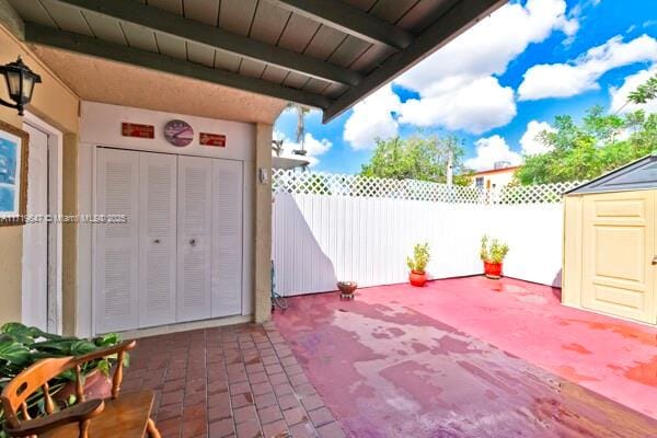 view of patio featuring a shed