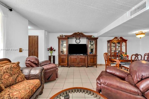 tiled living room with a textured ceiling