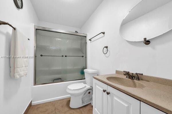 full bathroom with tile patterned flooring, vanity, bath / shower combo with glass door, and toilet