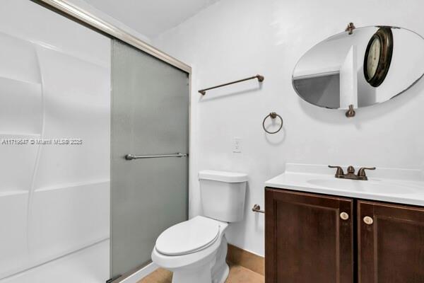 bathroom with vanity, toilet, and walk in shower