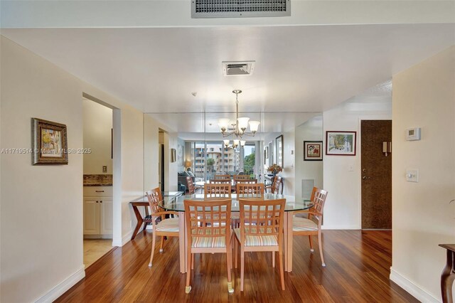 dining room with a chandelier and hardwood / wood-style flooring