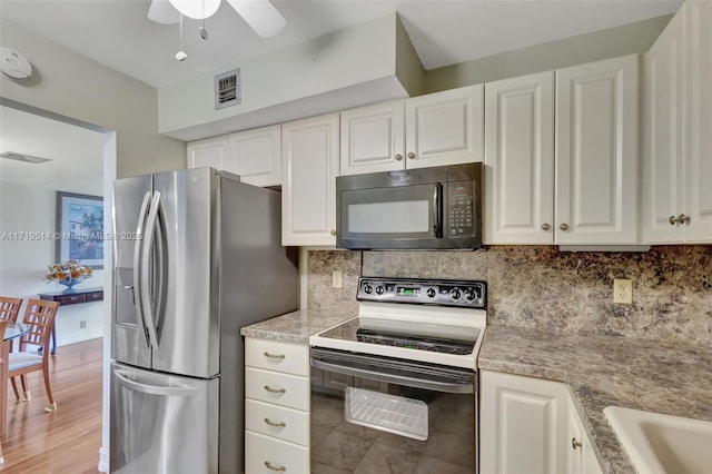 kitchen featuring stainless steel refrigerator with ice dispenser, white cabinets, backsplash, and electric stove