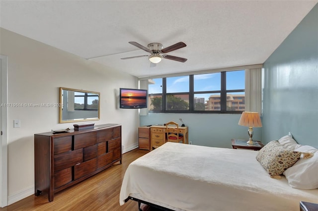 bedroom featuring ceiling fan and light wood-type flooring