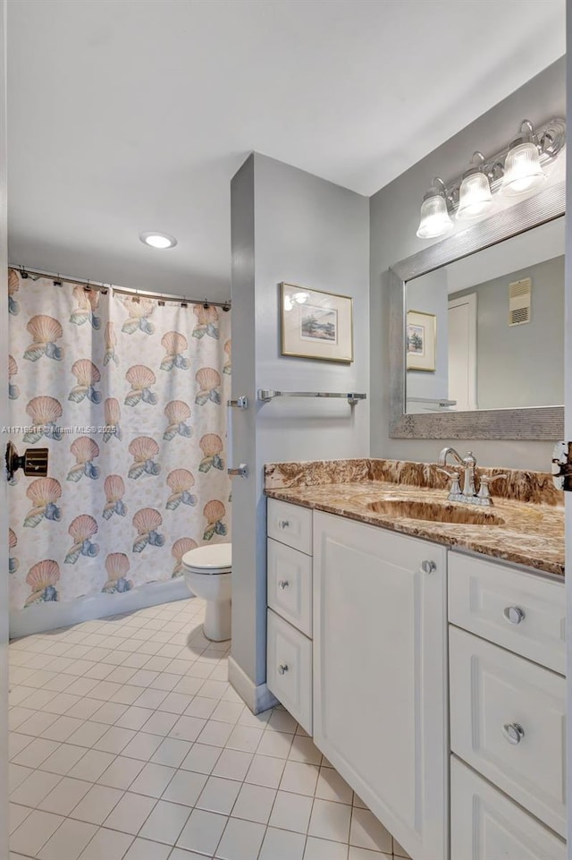 bathroom featuring vanity, toilet, curtained shower, and tile patterned flooring