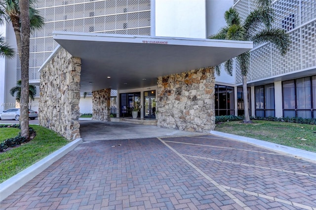 property entrance featuring a carport