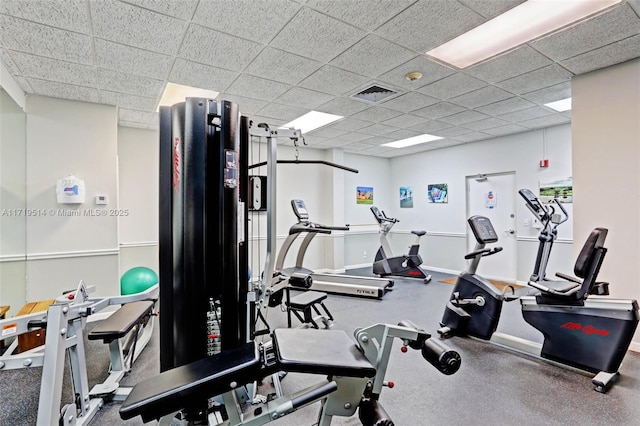 exercise room with a drop ceiling