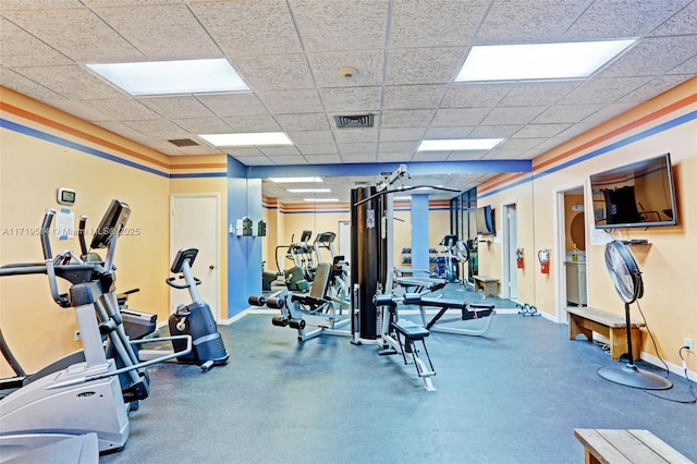 exercise room with a drop ceiling