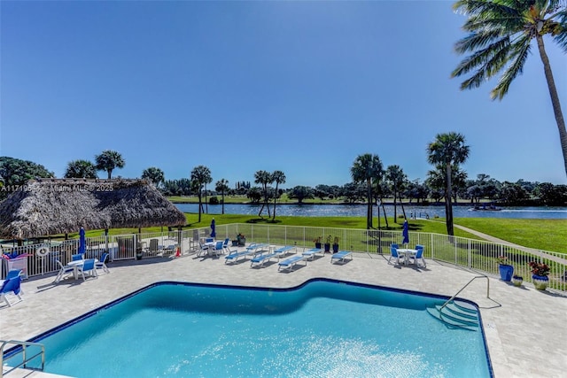 view of pool featuring a water view and a patio area