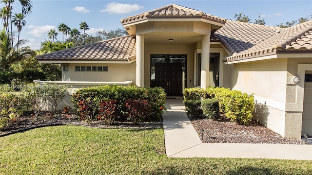 doorway to property with a lawn