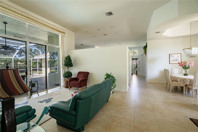 living room featuring light tile patterned floors and an inviting chandelier