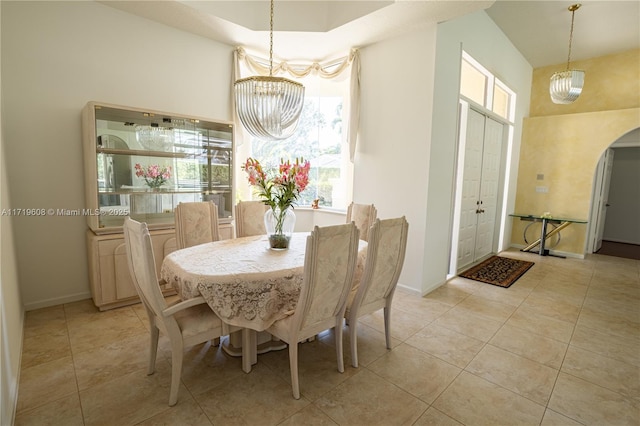 dining space with a chandelier, plenty of natural light, and light tile patterned flooring