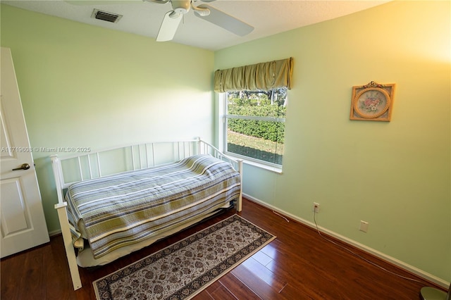 bedroom featuring ceiling fan and dark hardwood / wood-style floors