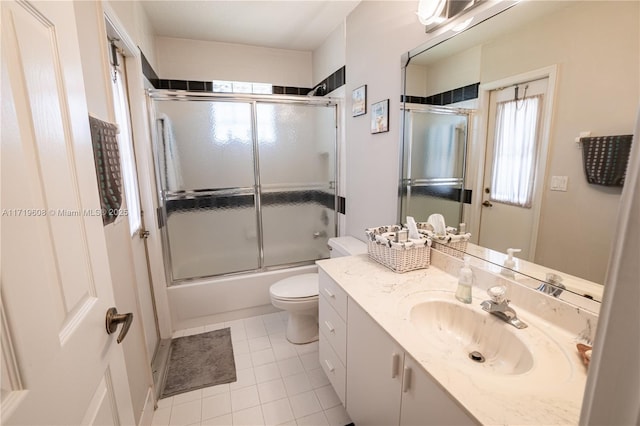 full bathroom featuring plenty of natural light, toilet, combined bath / shower with glass door, and vanity