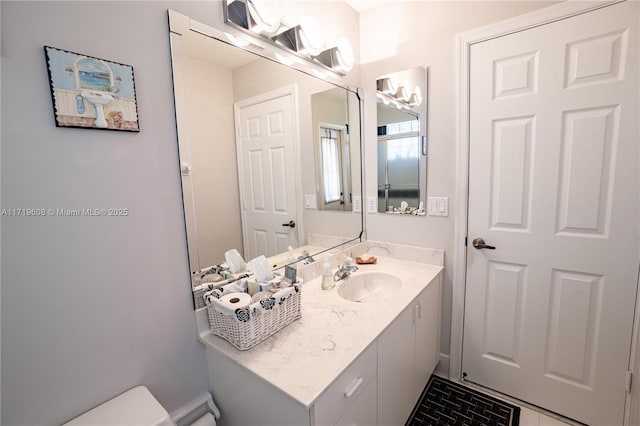 bathroom featuring vanity and toilet