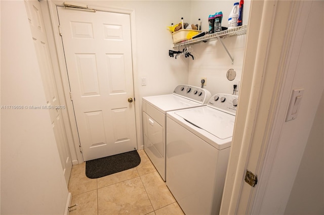 laundry area featuring independent washer and dryer and light tile patterned floors