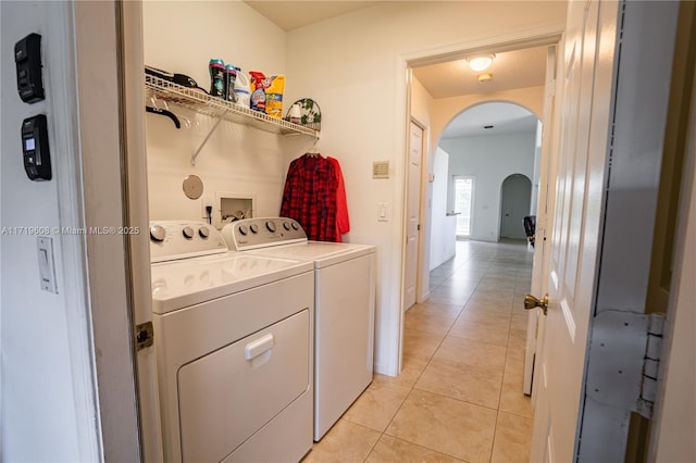 laundry room featuring independent washer and dryer and light tile patterned floors