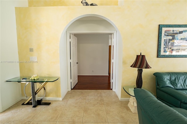 hall featuring light tile patterned floors