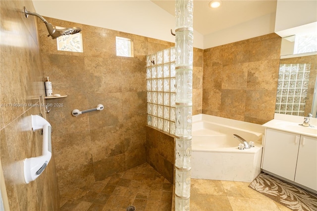 bathroom featuring vanity and independent shower and bath