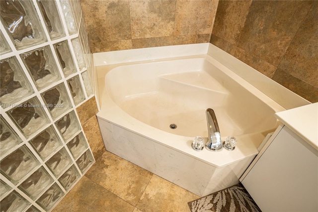 bathroom with a bathtub and tile walls