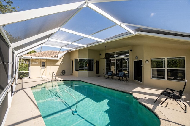 view of pool with a patio and a lanai