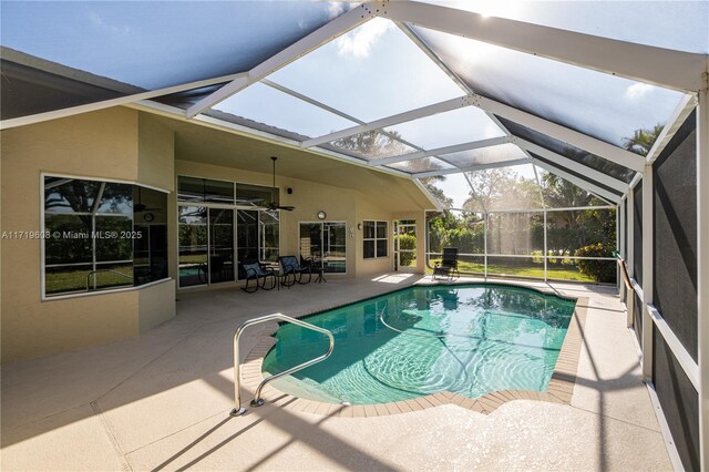 view of swimming pool with a lanai, ceiling fan, and a patio area