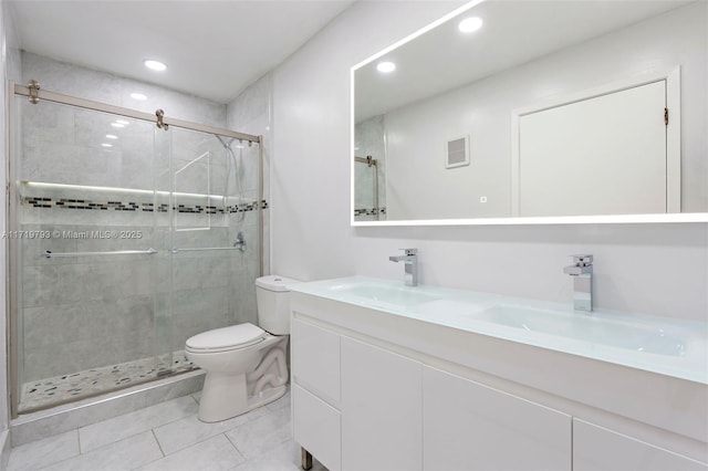 bathroom with tile patterned floors, vanity, toilet, and a shower with shower door