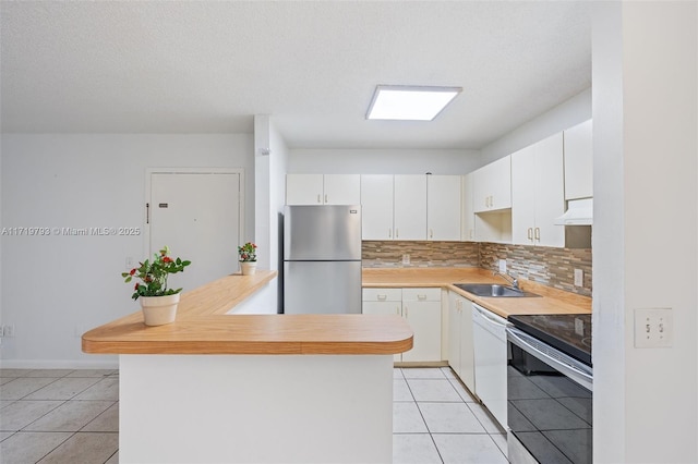 kitchen with decorative backsplash, appliances with stainless steel finishes, ventilation hood, sink, and light tile patterned flooring