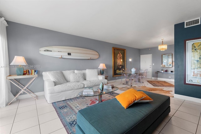 tiled living room featuring a notable chandelier