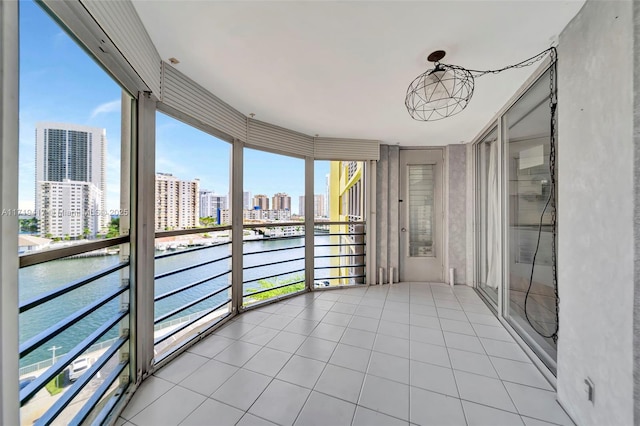 unfurnished sunroom with a water view