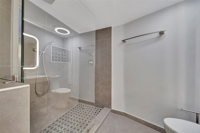 bathroom with tile patterned flooring, a tile shower, and toilet