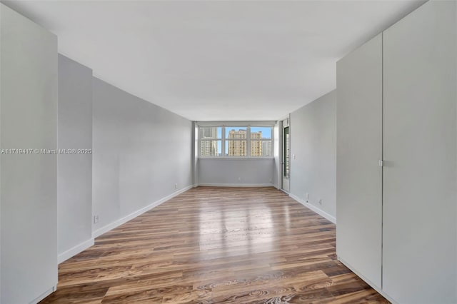 empty room with hardwood / wood-style floors