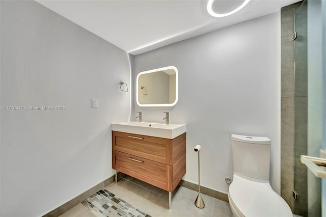 bathroom with tile patterned flooring, vanity, and toilet