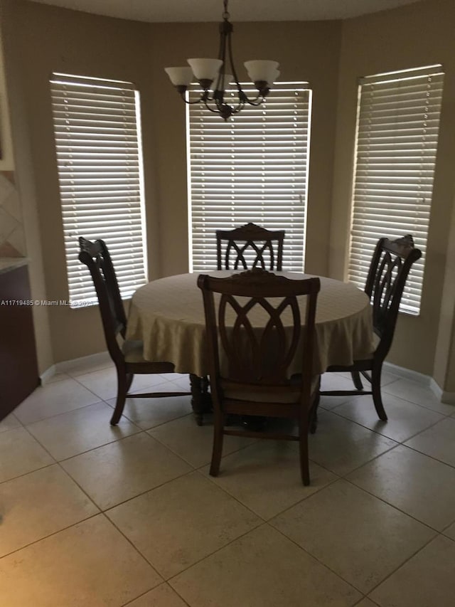 tiled dining area with a notable chandelier