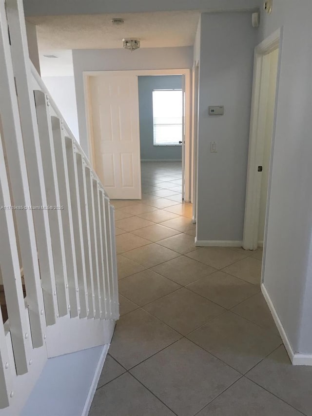 corridor featuring tile patterned flooring