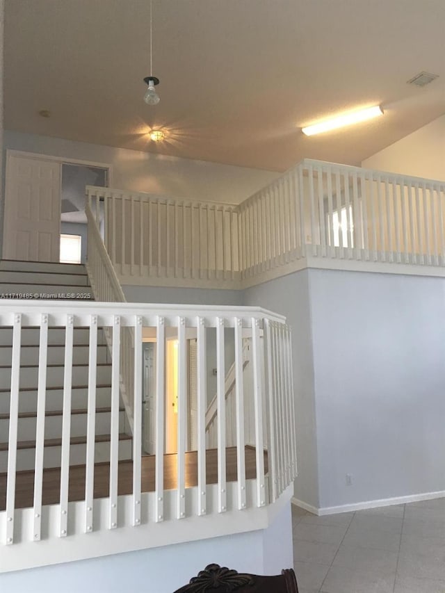 staircase with tile patterned floors